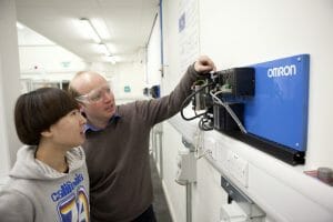 Alan Thorne, Technical Officer for the Automation Laboratory and MET course lecturer, demonstrates an Omron PLC to a student
